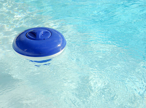 Floating Pool Chlorinator Used in swimming pools to distribute slow acting chlorine to kill bacteria and algae. chlorine stock pictures, royalty-free photos & images