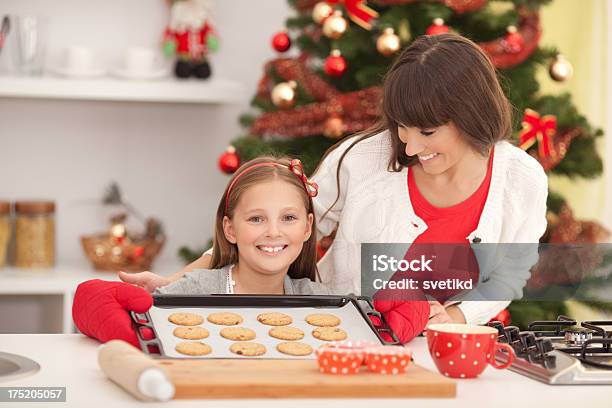 Mother And Daughter With Cookies By Christmas Tree Stock Photo - Download Image Now - 30-39 Years, 6-7 Years, Adult