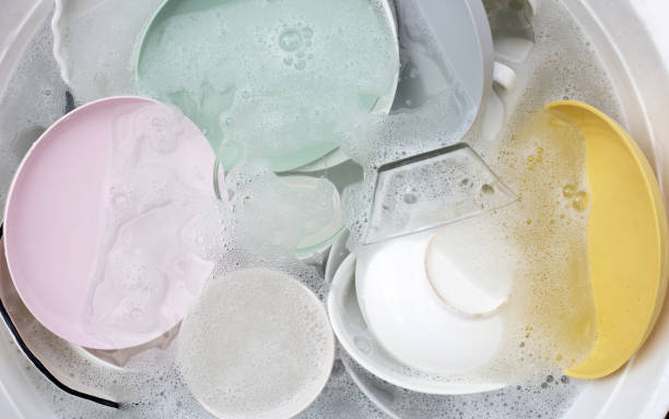 istock Dishes and bowls in water and bubbles of dishwashing liquid. Kitchen work 1752052094