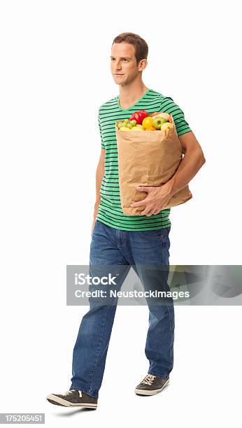 Hombre Caminando Con Bolsa De Comestibles Aislado Foto de stock y más banco de imágenes de Andar - Andar, Hombres, Personas