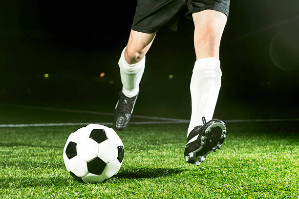 istock Soccer player kicks ball with full power 175205917