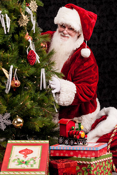 istock Real Santa Peeking Around Christmas Tree 175206138