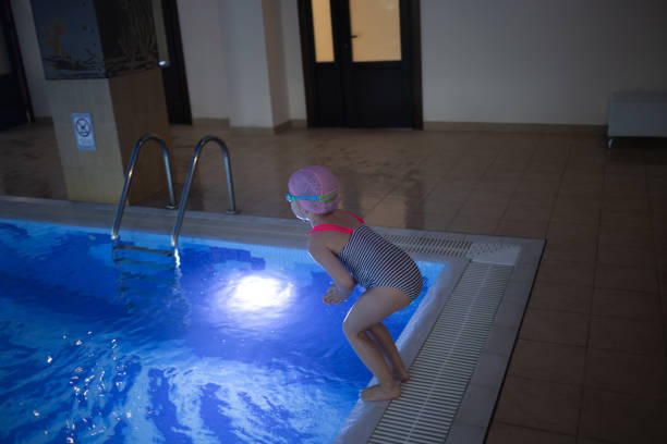 istock little cute girl performs exercises at the training in the pool 1752064419