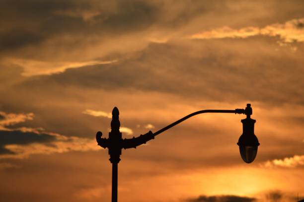 istock a lamp post at the end of a road with sunset behind it 1752066704