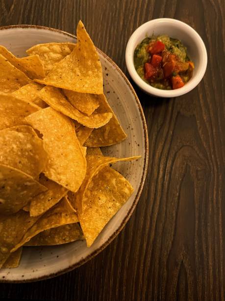 istock nacho chips sitting on a plate near a bowl with salsa 1752071250