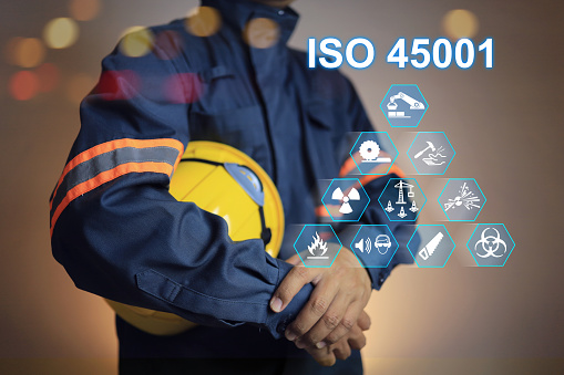 iso 45001 concept. workplace safety standard health and safety of employee or worker. Standard icons and safety symbols and staff holding helmet to encourage about safety work matter.