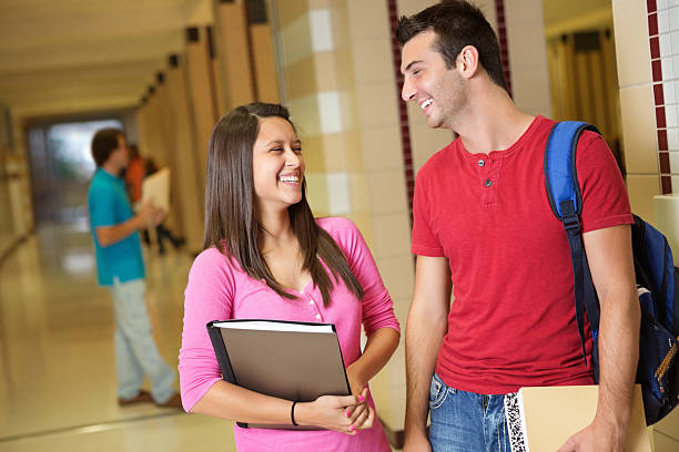 istock Friends laughing together in high school hallway 175207242