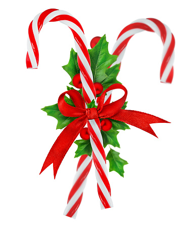 Two candy canes with a red ribbon and a decoration in the form of a sprig of holly. Highlighted on a white background