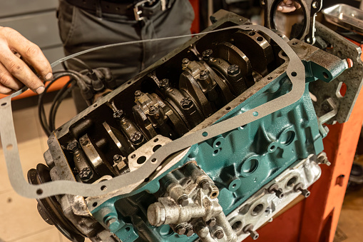 Close-up of a disassembled vintage engine in a workshop, undergoing meticulous restoration.