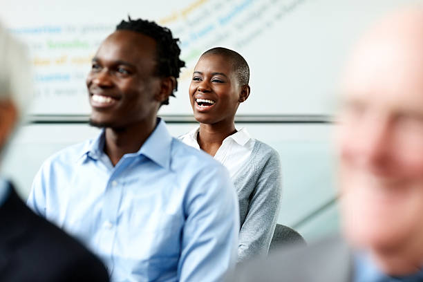 istock Smiling business people attending seminar 175208380