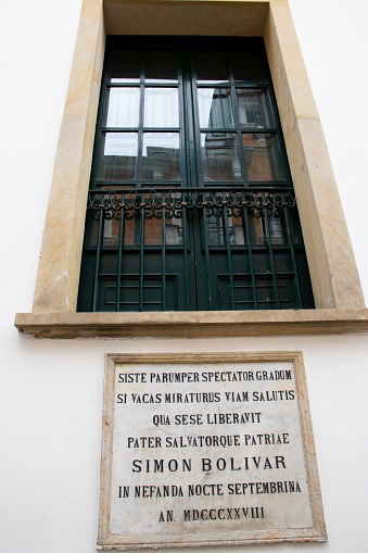 Bogota, Colombia - July 2nd 2023. Window of the San Carlos Palace through which Bolivar escaped from the attack, the plaque says stop, spectator, for a moment, and look at the place where the father and Liberator of the country, Simon Bolivar, was saved on the nefarious September night. Year 1828.