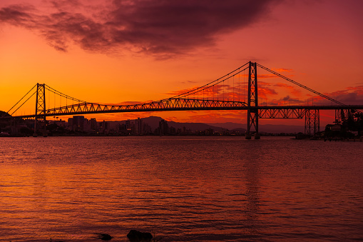 Hercilio luz cable stayed bridge and warm sunset with bright sky in Florianopolis