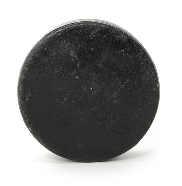 Close up of a black hockey puck Hockey puck.  hockey puck photos stock pictures, royalty-free photos & images