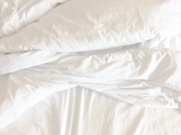 istock White pillow on bed and with wrinkle messy blanket in bedroom 1752101065