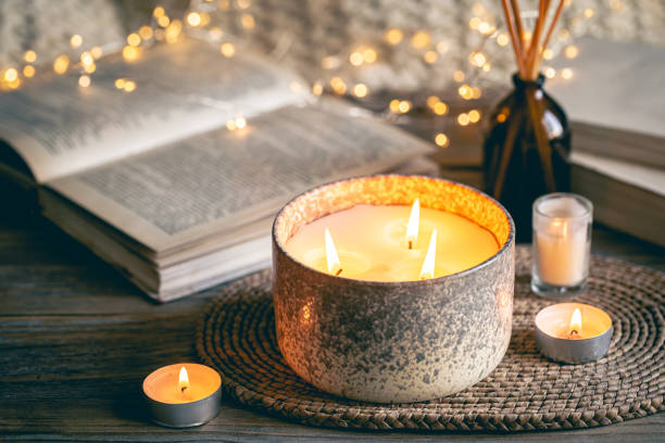istock Cozy winter composition with candles on a blurred background with books. 1752101675