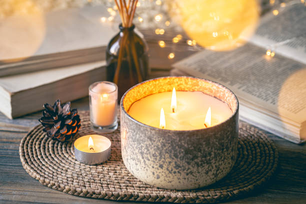 istock Cozy winter composition with candles on a blurred background with books. 1752101689