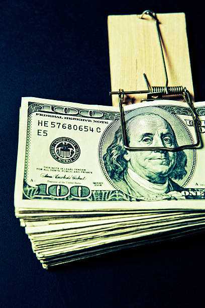 istock $100 dollar bills trapped by traditional mousetrap: the credit squeeze! 175211030