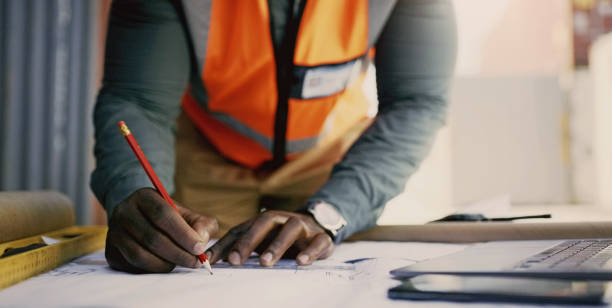 istock Engineering hands, drawing and blueprint planning at construction site, warehouse and outdoor development. Architecture contractor, project manager or person with floor plan, lines and sketch tools 1752117509