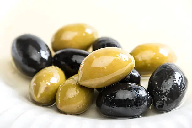 "Bella De Cerignola Olives (black, and green) on white background"