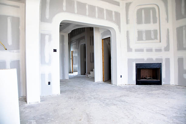 Interior of new homes construction site Interior of new homes construction site. Sheetrock is up, ready for paint. drywall fireplace stock pictures, royalty-free photos & images