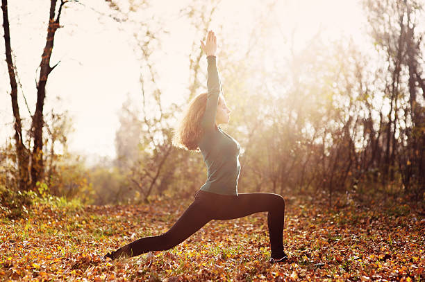 istock Woman doing yoga exercise in the woods 175212445
