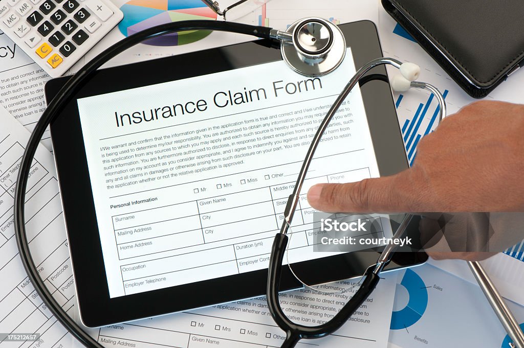 Insurance claim form with stethoscope Insurance claim form with stethoscope on a desk Accidents and Disasters Stock Photo