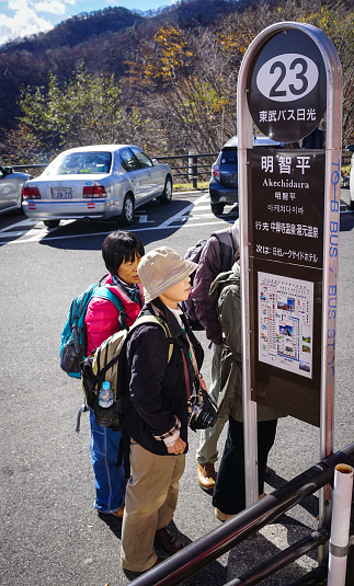 Nikko, Japan - Nov 3, 2014. People waiting at bus station in Nikko, Japan. Nikko has a lot of monuments to visit featuring on UNESCO World Heritage sites.