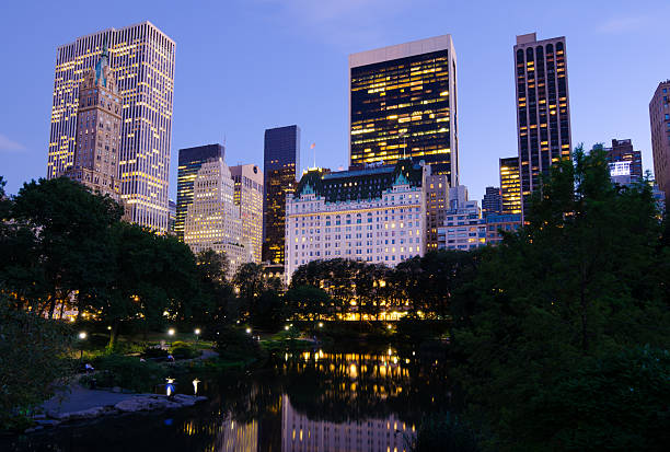 Plaza Hotel and other buildings as seen from Central Park at night.