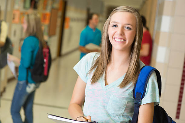 istock Happy high school girl in campus hallway 175214896