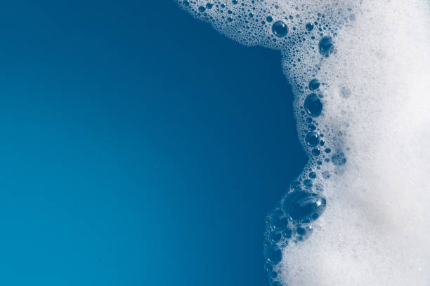 istock Detergent foam bubble on water. Blue background, Soap sud 1752151093