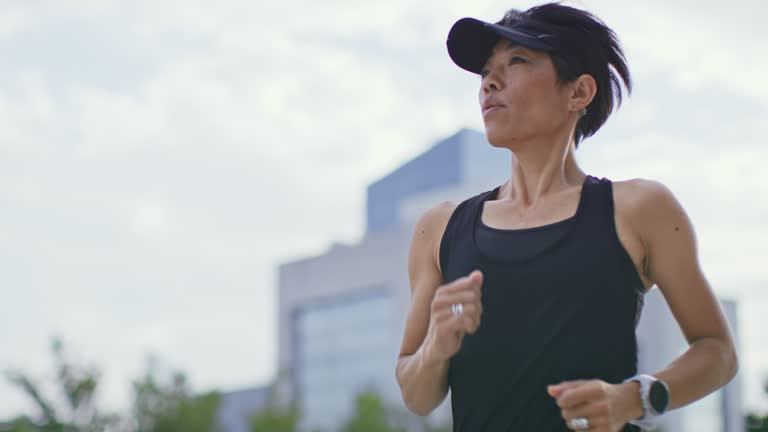 SLO MO TS Fit Asian woman running in the city