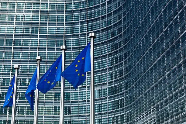 "european flags in front of the european commission building in brussels, belgium."