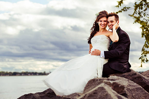 istock Bride and groom sitting on a rock 175216097