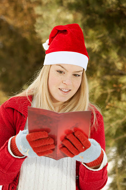 istock young woman reading Christmas greeting card 175216636