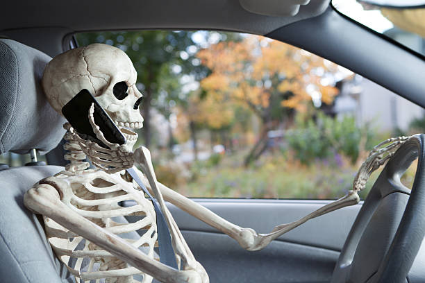 istock Inattentive Driver Talking on Smart Phone Symbolizing Car Death Hazard 175216872