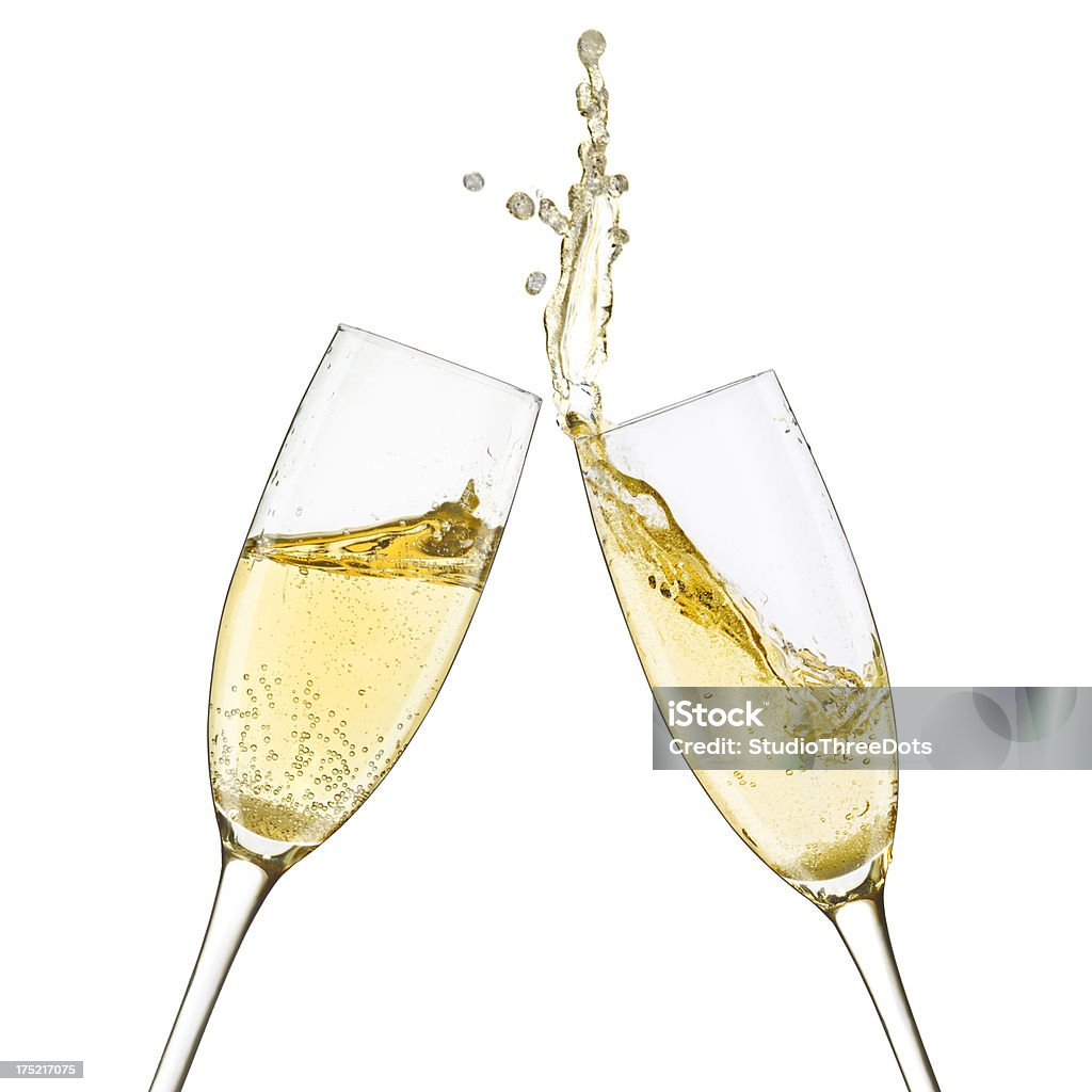 Champagne Glasses Splash Close up shot of a toast and splash with two champagne glasses. Isolated on white. White Wine Stock Photo