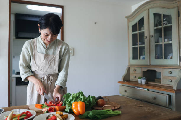 istock Older Female Prepares a Vegan Meal 1752170827