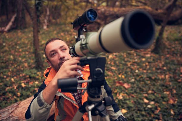 istock Man using telescope for bird and animal watching in nature. 1752172626