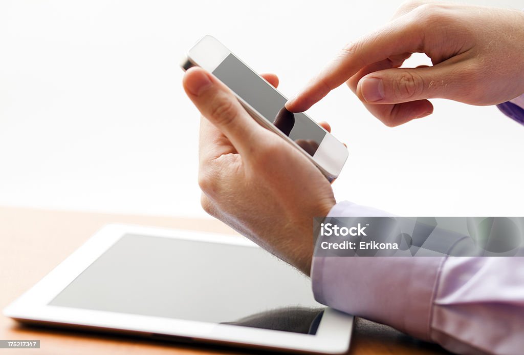 Touching Screen Smart Phone Businessman Touching Screen Smart Phone and Tablet PC Adult Stock Photo