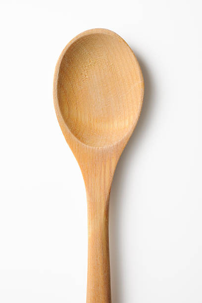 Isolated shot of wooden spoon with shadow on white background Close-up shot of wooden spoon isolated on white background with clipping path. wooden spoon stock pictures, royalty-free photos & images