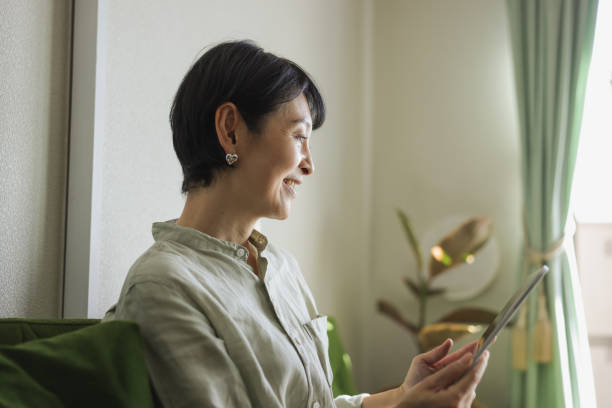 Mature Woman At Home on Tablet