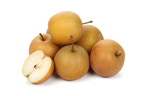 Ripe pear, half and piece close-up on a white background. Isolated