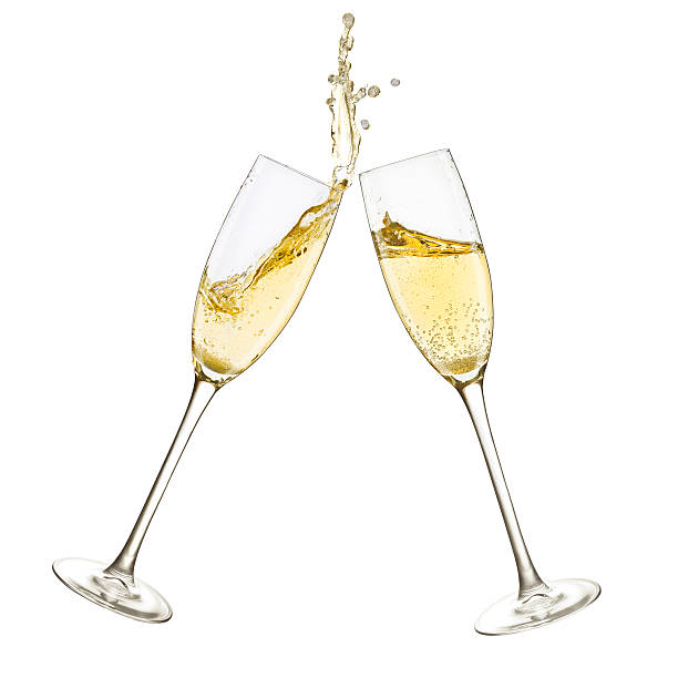Champagne Glasses Splash Close up shot of a toast and splash with two champagne glasses. Isolated on white. celebratory toast photos stock pictures, royalty-free photos & images