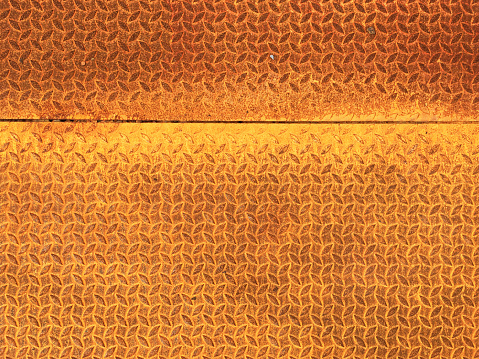 Rust on metallic surface. Rusted iron texture. Rusty metal background with copy space. Rough oxide plate close up. Strong rust. Hard decay of metal in macro. Oxidation of steel. Chemical reaction.