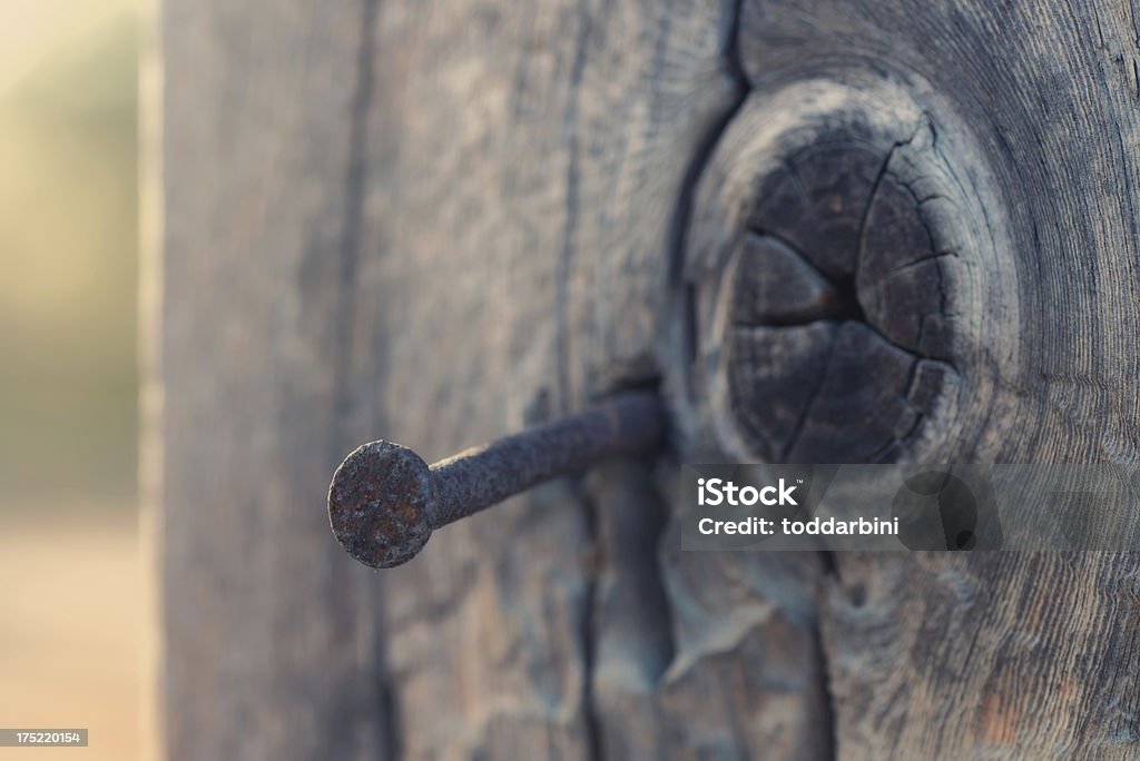 Rusty Nail Close-up A close-up of a rusty nail by a knot in the wood.High Resolution: XXXLNikon D800 DSLR; Nikkor 105mm Micro Lens; RAW Close-up Stock Photo