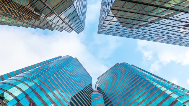 High rise Hong Kong skyscraper with reflection cloud timelapse