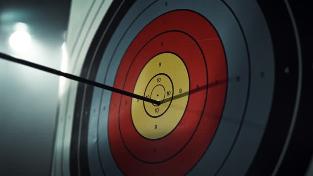 Slow Motion of an Arrow Hitting a Target. Close Up on an Arrow Hitting the Bullseye on a Colorful Board. Talented Athlete Practising for a Championship. Aesthetic Static Footage