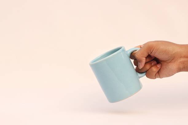 istock hand holding a cup of coffee 1752209166