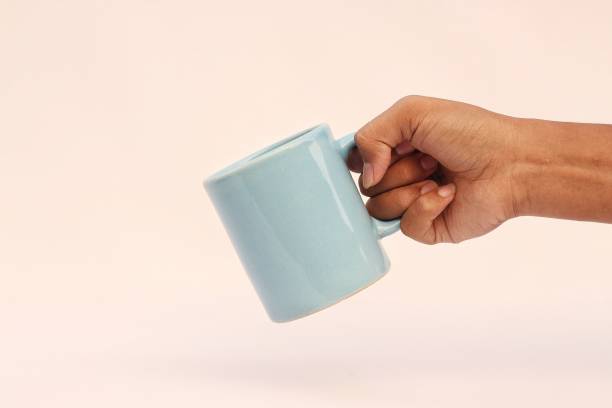 istock hand holding a cup of coffee 1752209171