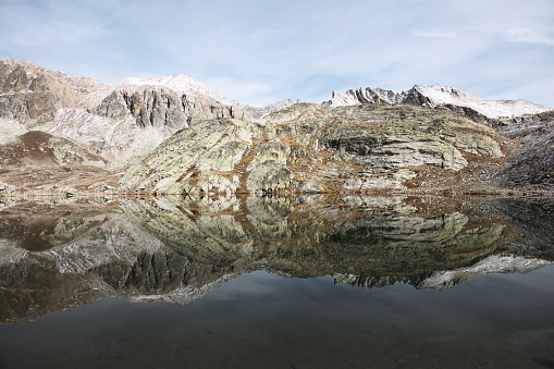 In a landscape of roches montagne, rounded quatzite bumps eroded by ancient glaciers, the 4 main lakes of Roure take place in basins formerly dug by the ice.\n\nThe photo is taken in a northeast direction towards the teeth of Maniglia 3166m and Mont de Maniglia 3180m visible in the background to the right of the image